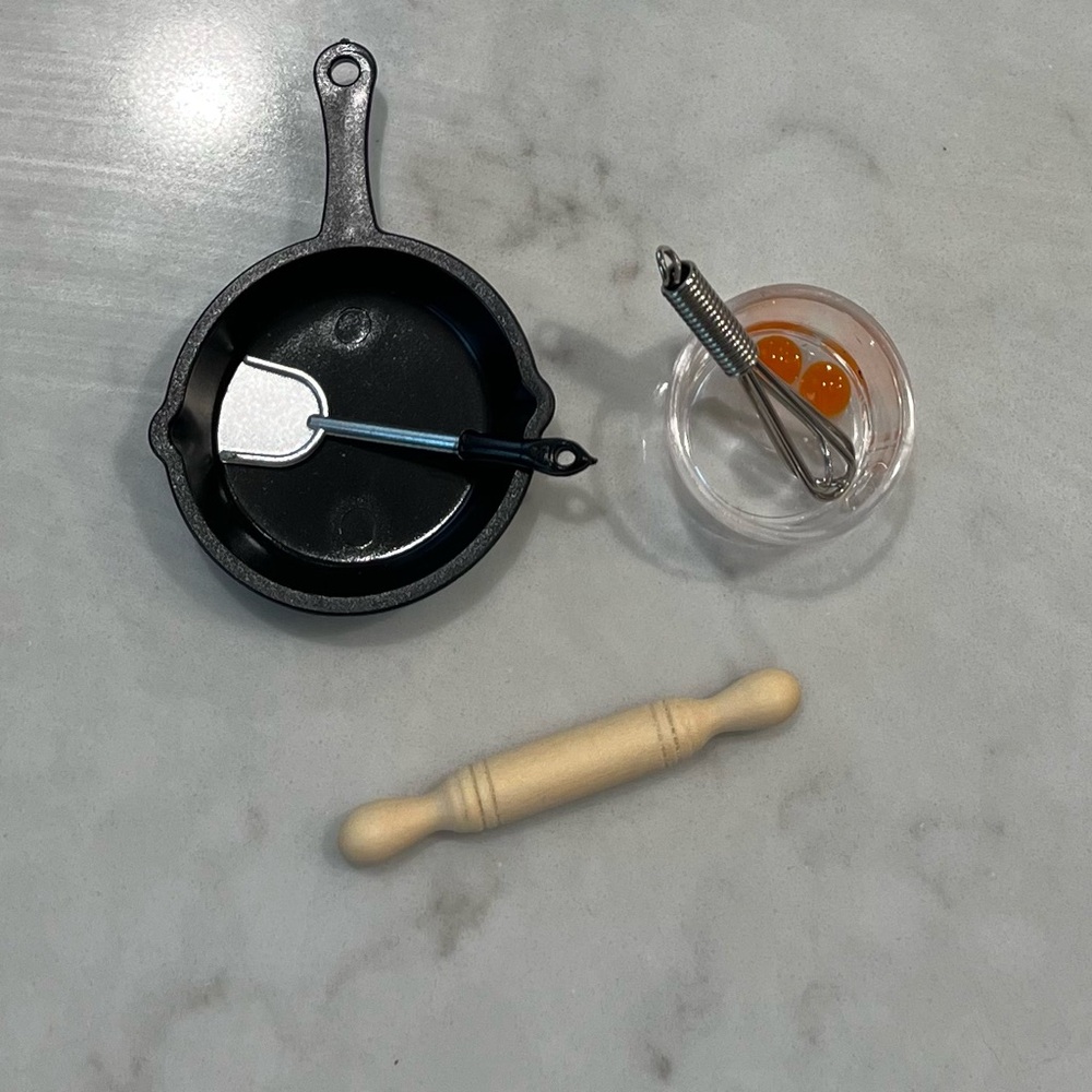 New Barbie Size rolling pin, whisk,pan, spatula, mixing bowl with eggs. Dishes